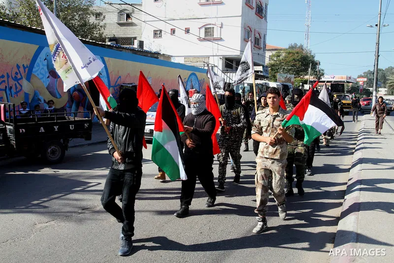 Palestinian youths loyal to the Hamas movement march during a rally in Khan Yunis in the southern Gaza Strip, December 8, 2016. Photo by Abed Rahim Khatib