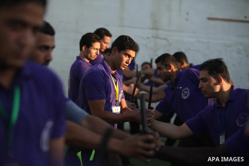 Palestinian applicants for a private security guard job at Castle Security company undergo a physical examination in an open-air playground in Gaza City on December 08, 2016. Photo by Ashraf Amra
