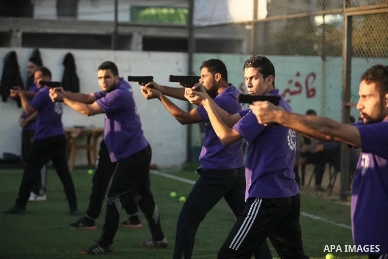 Palestinian applicants for a private security guard job at Castle Security company undergo a physical examination in an open-air playground in Gaza City on December 08, 2016. Photo by Ashraf Amra