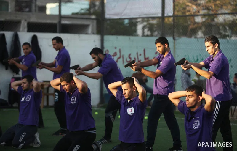 Palestinian applicants for a private security guard job at Castle Security company undergo a physical examination in an open-air playground in Gaza City on December 08, 2016. Photo by Ashraf Amra