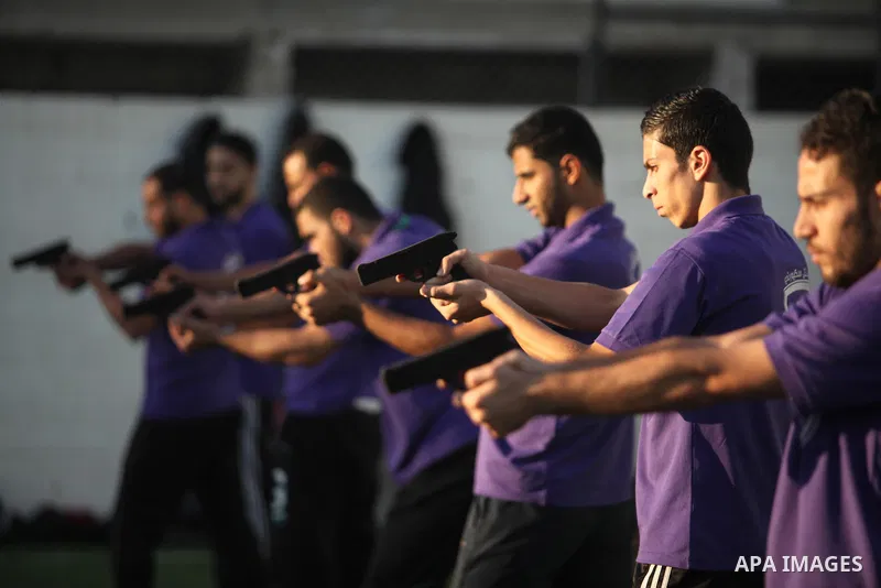 Palestinian applicants for a private security guard job at Castle Security company undergo a physical examination in an open-air playground in Gaza City on December 08, 2016. Photo by Ashraf Amra