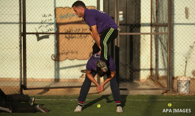 Palestinian applicants for a private security guard job at Castle Security company undergo a physical examination in an open-air playground in Gaza City on December 08, 2016. Photo by Ashraf Amra