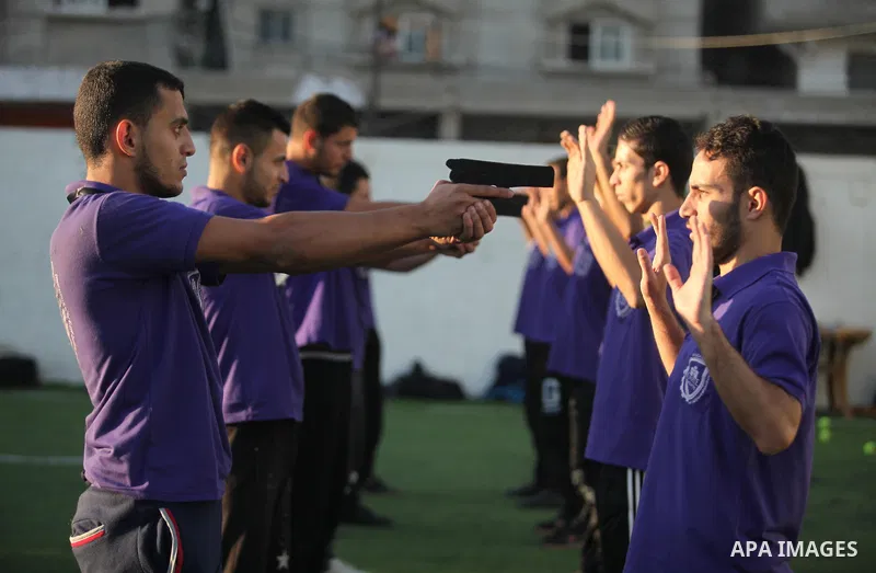 Palestinian applicants for a private security guard job at Castle Security company undergo a physical examination in an open-air playground in Gaza City on December 08, 2016. Photo by Ashraf Amra