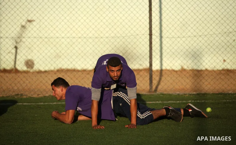 Palestinian applicants for a private security guard job at Castle Security company undergo a physical examination in an open-air playground in Gaza City on December 08, 2016. Photo by Ashraf Amra