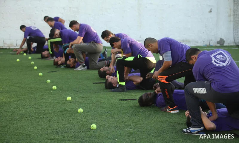 Palestinian applicants for a private security guard job at Castle Security company undergo a physical examination in an open-air playground in Gaza City on December 08, 2016. Photo by Ashraf Amra