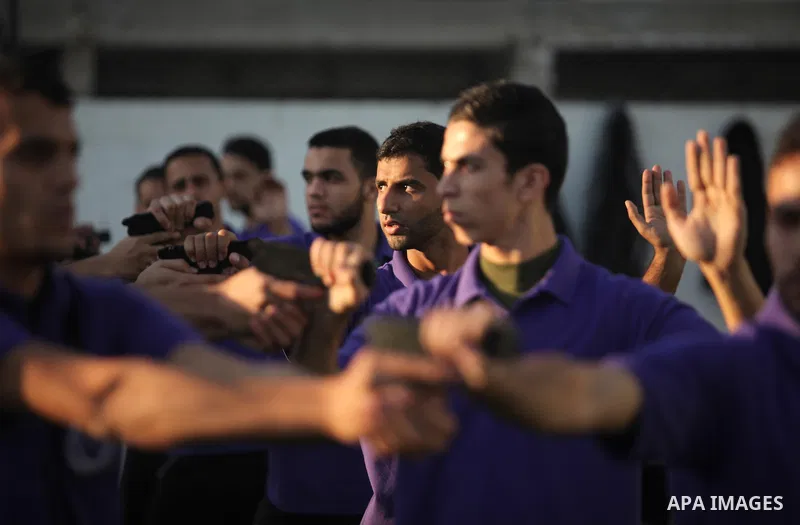 Palestinian applicants for a private security guard job at Castle Security company undergo a physical examination in an open-air playground in Gaza City on December 08, 2016. Photo by Ashraf Amra