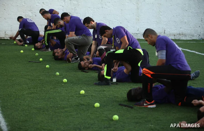 Palestinian applicants for a private security guard job at Castle Security company undergo a physical examination in an open-air playground in Gaza City on December 08, 2016. Photo by Ashraf Amra