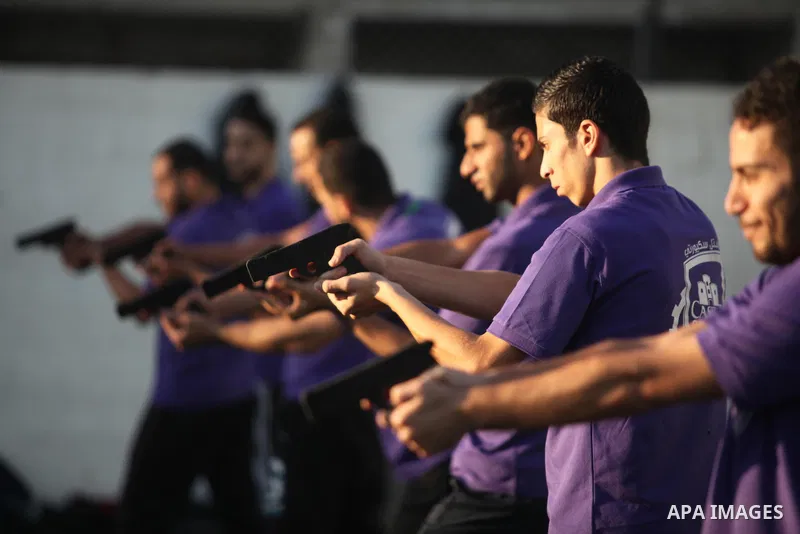Palestinian applicants for a private security guard job at Castle Security company undergo a physical examination in an open-air playground in Gaza City on December 08, 2016. Photo by Ashraf Amra