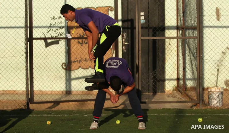 Palestinian applicants for a private security guard job at Castle Security company undergo a physical examination in an open-air playground in Gaza City on December 08, 2016. Photo by Ashraf Amra