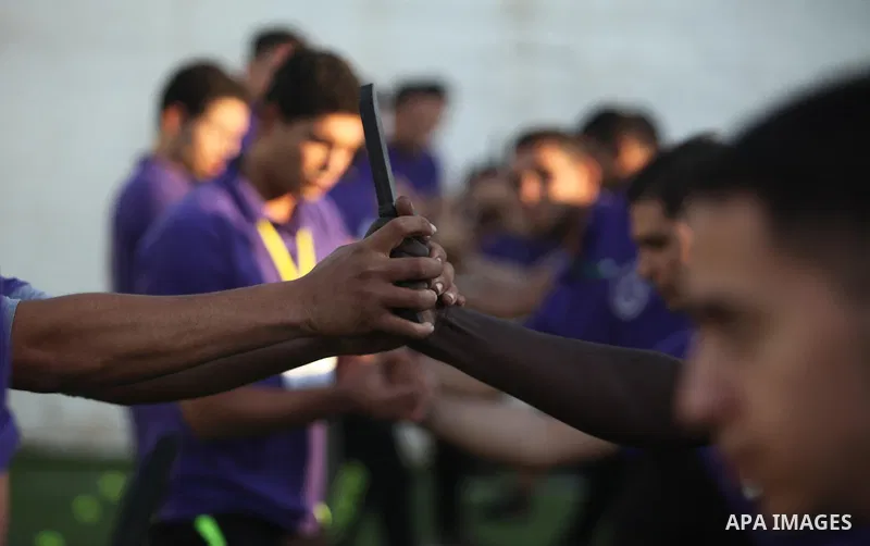 Palestinian applicants for a private security guard job at Castle Security company undergo a physical examination in an open-air playground in Gaza City on December 08, 2016. Photo by Ashraf Amra