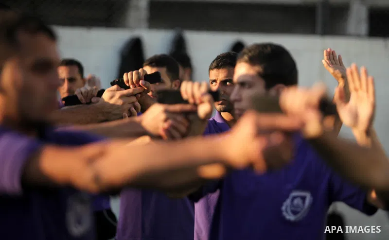 Palestinian applicants for a private security guard job at Castle Security company undergo a physical examination in an open-air playground in Gaza City on December 08, 2016. Photo by Ashraf Amra
