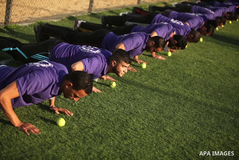 Palestinian applicants for a private security guard job at Castle Security company undergo a physical examination in an open-air playground in Gaza City on December 08, 2016. Photo by Ashraf Amra
