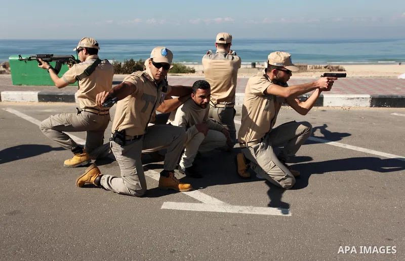 Palestinian private security guards from Castle Security company take part in an exercise during a simulation on how to secure important characters, in Gaza City on December 08, 2016. Photo by Ashraf Amra