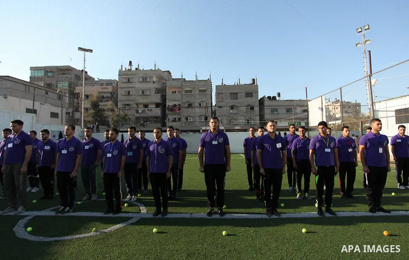 Palestinian applicants for a private security guard job at Castle Security company undergo a physical examination in an open-air playground in Gaza City on December 08, 2016. Photo by Ashraf Amra