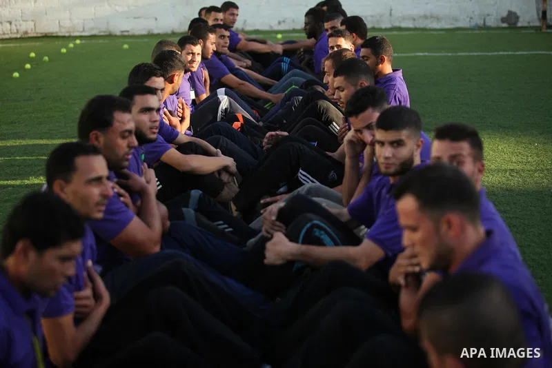 Palestinian applicants for a private security guard job at Castle Security company undergo a physical examination in an open-air playground in Gaza City on December 08, 2016. Photo by Ashraf Amra