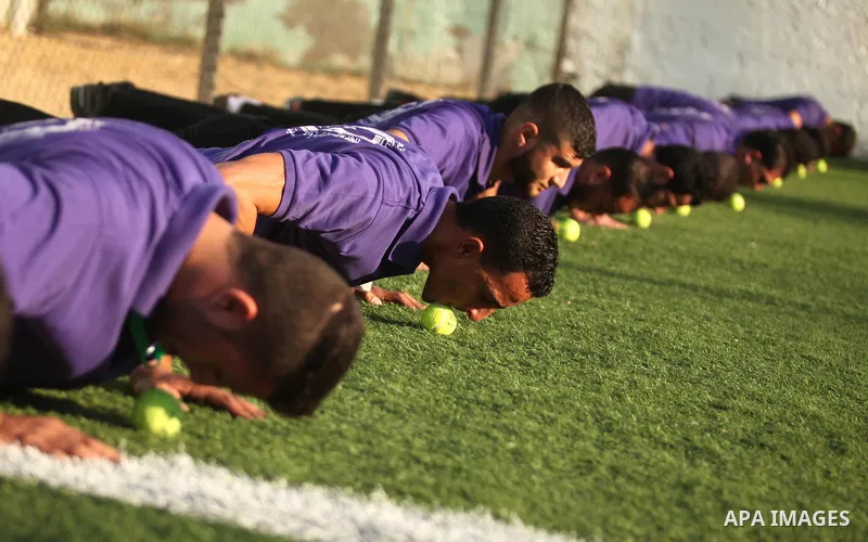 Palestinian applicants for a private security guard job at Castle Security company undergo a physical examination in an open-air playground in Gaza City on December 08, 2016. Photo by Ashraf Amra