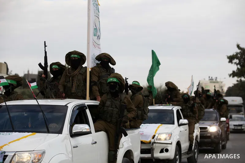 Members of the Ezzedine al-Qassam Brigades, the military wing of the Palestinian Islamist movement Hamas, take part in a rally marking the 29th anniversary of Hamas foundation, in Jabalia in the northern of Gaza Strip, o...