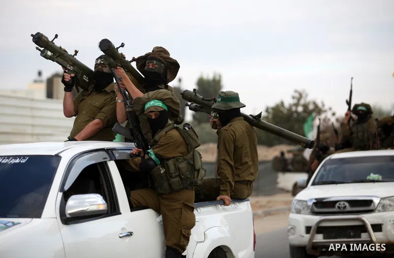 Members of the Ezzedine al-Qassam Brigades, the military wing of the Palestinian Islamist movement Hamas, take part in a rally marking the 29th anniversary of Hamas foundation, in Jabalia in the northern of Gaza Strip, o...