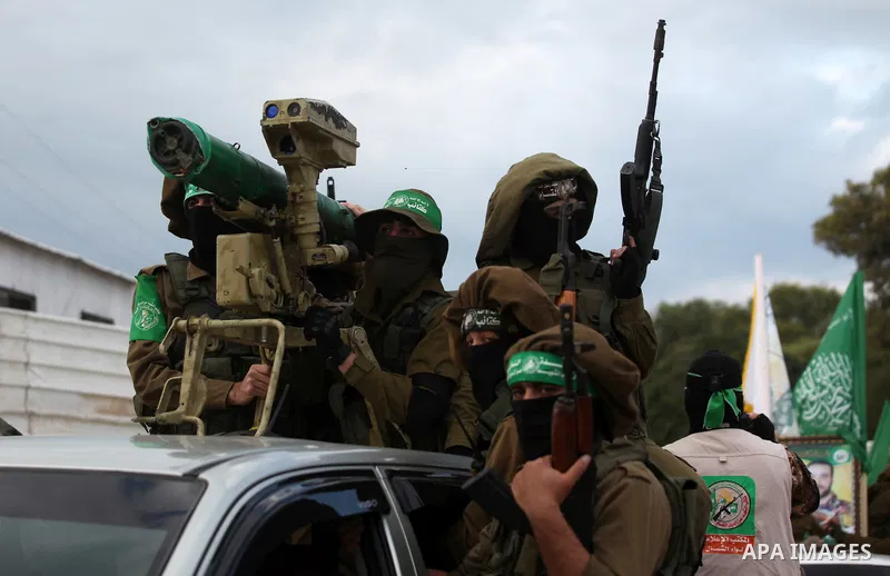 Members of the Ezzedine al-Qassam Brigades, the military wing of the Palestinian Islamist movement Hamas, take part in a rally marking the 29th anniversary of Hamas foundation, in Jabalia in the northern of Gaza Strip, o...