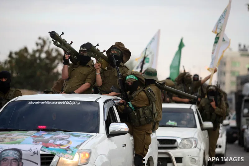 Members of the Ezzedine al-Qassam Brigades, the military wing of the Palestinian Islamist movement Hamas, take part in a rally marking the 29th anniversary of Hamas foundation, in Jabalia in the northern of Gaza Strip, o...
