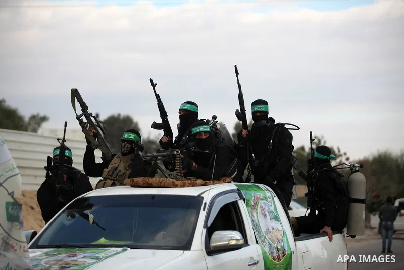 Members of the Ezzedine al-Qassam Brigades, the military wing of the Palestinian Islamist movement Hamas, take part in a rally marking the 29th anniversary of Hamas foundation, in Jabalia in the northern of Gaza Strip, o...