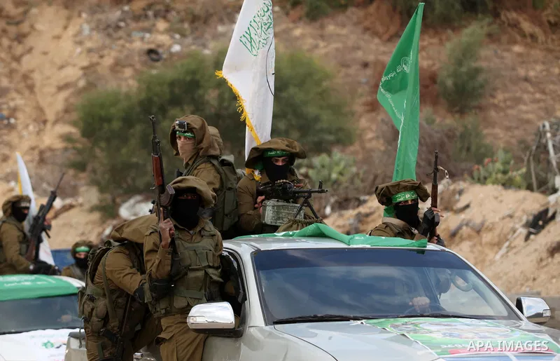 Members of the Ezzedine al-Qassam Brigades, the military wing of the Palestinian Islamist movement Hamas, take part in a rally marking the 29th anniversary of Hamas foundation, in Jabalia in the northern of Gaza Strip, o...