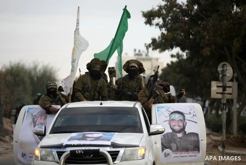 Members of the Ezzedine al-Qassam Brigades, the military wing of the Palestinian Islamist movement Hamas, take part in a rally marking the 29th anniversary of Hamas foundation, in Jabalia in the northern of Gaza Strip, o...