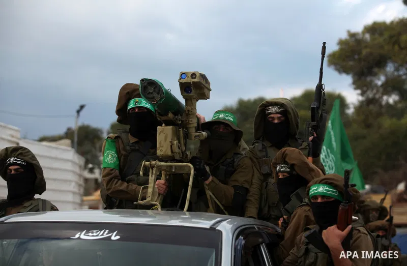 Members of the Ezzedine al-Qassam Brigades, the military wing of the Palestinian Islamist movement Hamas, take part in a rally marking the 29th anniversary of Hamas foundation, in Jabalia in the northern of Gaza Strip, o...
