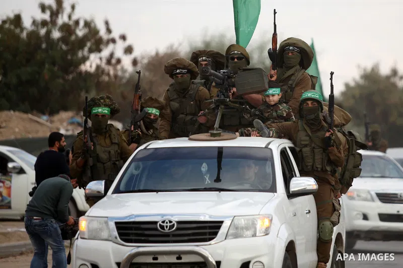 Members of the Ezzedine al-Qassam Brigades, the military wing of the Palestinian Islamist movement Hamas, take part in a rally marking the 29th anniversary of Hamas foundation, in Jabalia in the northern of Gaza Strip, o...