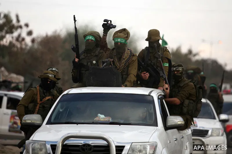 Members of the Ezzedine al-Qassam Brigades, the military wing of the Palestinian Islamist movement Hamas, take part in a rally marking the 29th anniversary of Hamas foundation, in Jabalia in the northern of Gaza Strip, o...