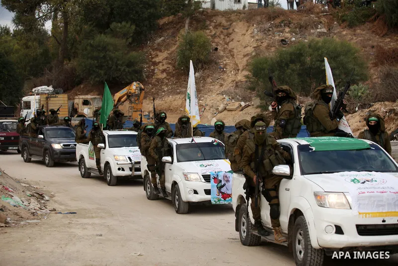Members of the Ezzedine al-Qassam Brigades, the military wing of the Palestinian Islamist movement Hamas, take part in a rally marking the 29th anniversary of Hamas foundation, in Jabalia in the northern of Gaza Strip, o...