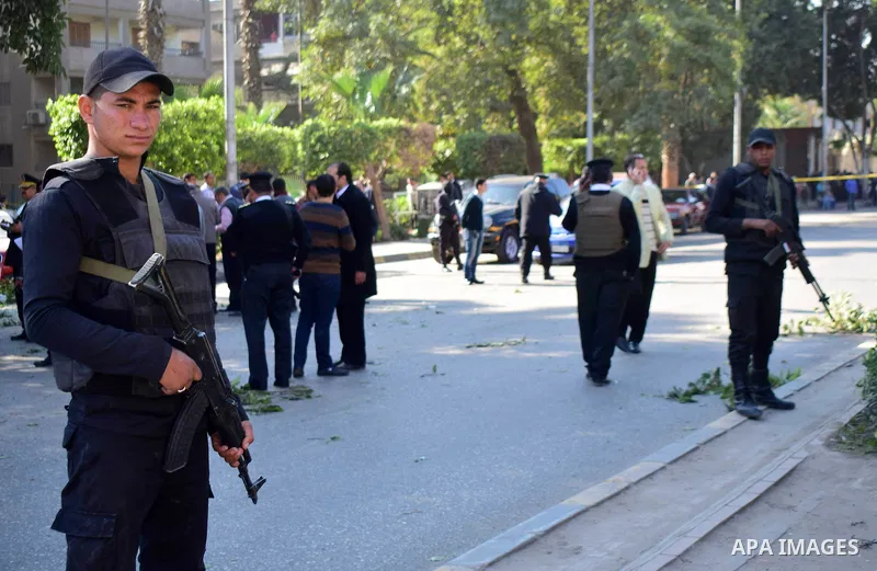 Egyptian special police officers stand guard at the scene of a bomb blast in Giza Al Haram Street on the outskirts of Cairo, Egypt December 9, 2016. Photo by Amr Sayed