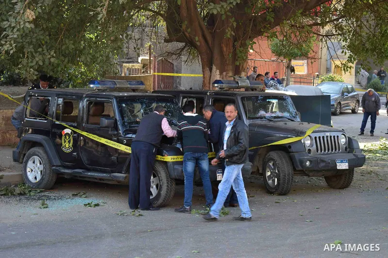 Egyptian security officials and investigators inspect the scene of a bomb blast in Giza Al Haram Street on the outskirts of Cairo, Egypt December 9, 2016. Photo by Amr Sayed