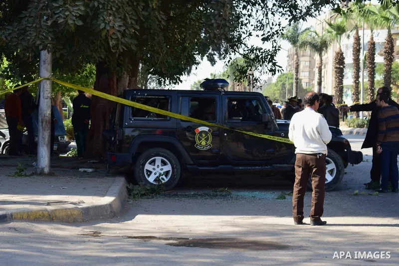 Egyptian security officials and investigators inspect the scene of a bomb blast in Giza Al Haram Street on the outskirts of Cairo, Egypt December 9, 2016. Photo by Amr Sayed