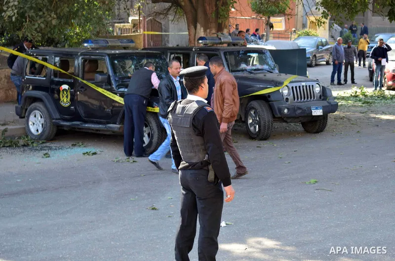 Egyptian security officials and investigators inspect the scene of a bomb blast in Giza Al Haram Street on the outskirts of Cairo, Egypt December 9, 2016. Photo by Amr Sayed