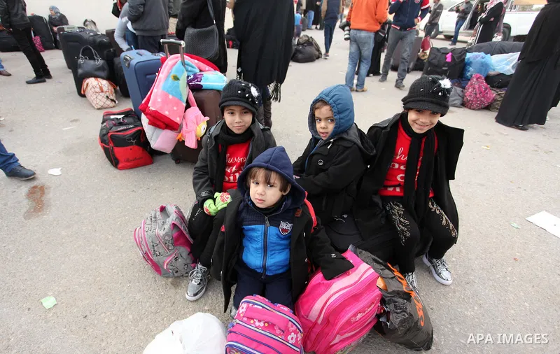 Palestinians wait for travel permits to cross into Egypt through the Rafah border crossing after it was opened by Egyptian authorities for humanitarian cases, in Rafah in the southern Gaza Strip December 10, 2016. An off...