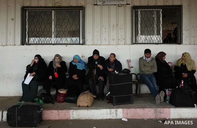 Palestinians wait for travel permits to cross into Egypt through the Rafah border crossing after it was opened by Egyptian authorities for humanitarian cases, in Rafah in the southern Gaza Strip December 10, 2016. An off...