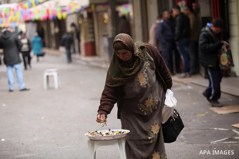 Palestinians eat candy during a ritual ceremony to commemorate the birth of the Prophet Mohammed, known in Arabic as "al-Mawlid al-Nabawi", in the West Bank city of Nablus on December 11, 2016. Photo by Nedal Eshtayah