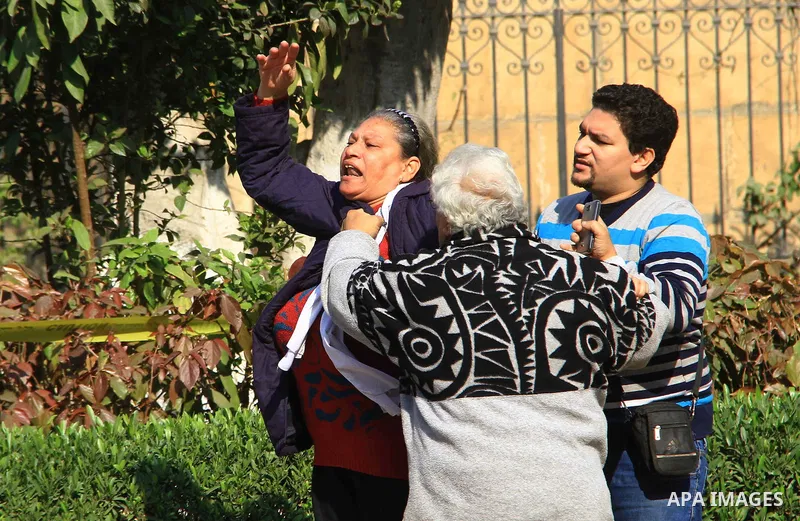 A relative of one of the blast victims reacts at the scene of a bomb explosion at the Saint Peter and Saint Paul Coptic Orthodox Church on December 11, 2016, in Cairo's Abbasiya neighbourhood. The blast killed at least 2...