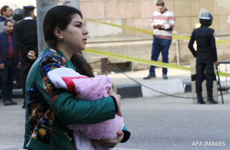 A relative of one of the blast victims reacts at the scene of a bomb explosion at the Saint Peter and Saint Paul Coptic Orthodox Church on December 11, 2016, in Cairo's Abbasiya neighbourhood. The blast killed at least 2...