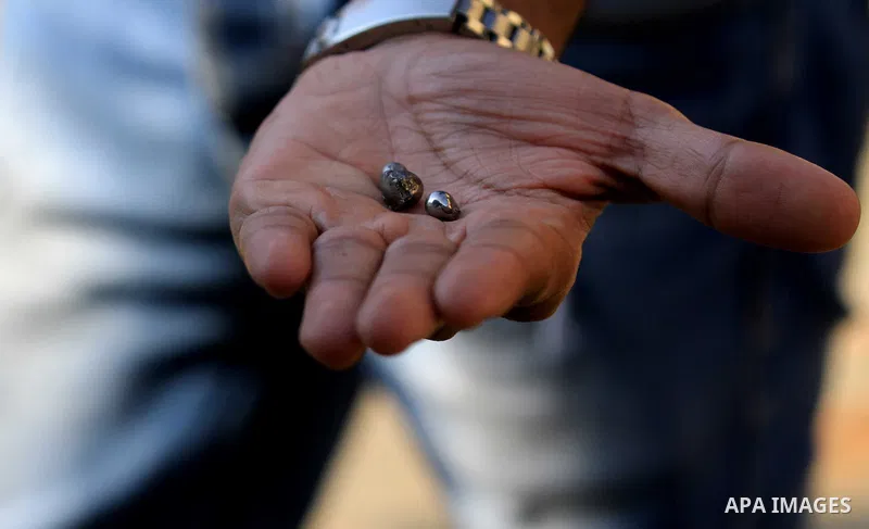 An Egyptian man shows small pieces of metal outside the Saint Peter and Saint Paul Coptic Orthodox Church after it was targeted by a bomb explosion on December 11, 2016, in Cairo's Abbasiya neighbourhood. The blast kille...