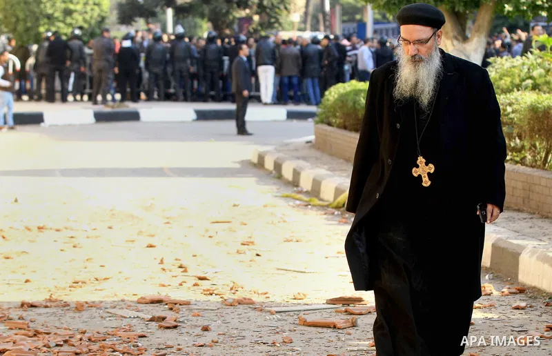 Egyptians inspect the scene of a bomb explosion at the Saint Peter and Saint Paul Coptic Orthodox Church on December 11, 2016, in Cairo's Abbasiya neighbourhood. The blast killed at least 25 worshippers during Sunday mas...