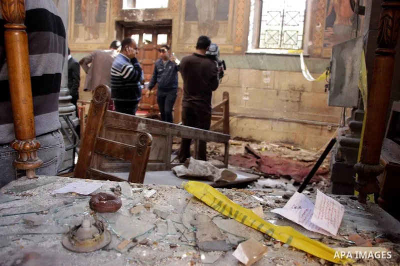 Egyptian security officials and investigators inspect the scene following a bombing inside the Saint Peter and Saint Paul Coptic Orthodox Church in Cairo's Abbasiya neighbourhood on December 11, 2016, . The blast killed...