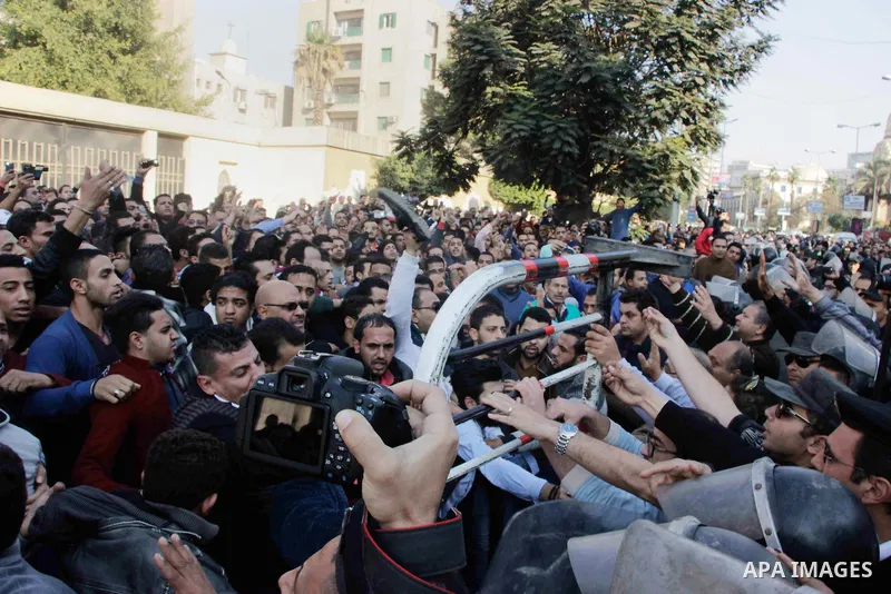 Egyptian Christians chant anti-terrorism slogans outside the the Saint Peter and Saint Paul Coptic Orthodox Church in Cairo's Abbasiya neighbourhood after it was targeted by a bomb explosion on December 11, 2016, . The b...
