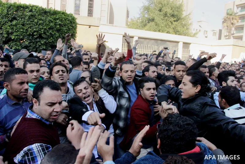 Egyptian Christians chant anti-terrorism slogans outside the the Saint Peter and Saint Paul Coptic Orthodox Church in Cairo's Abbasiya neighbourhood after it was targeted by a bomb explosion on December 11, 2016, . The b...