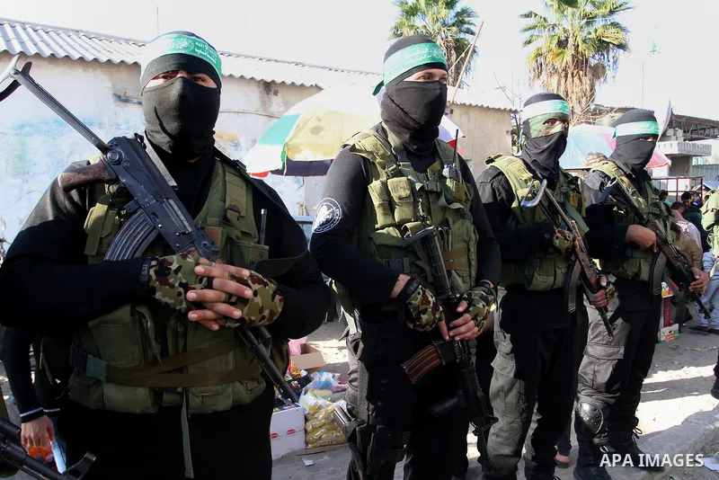 Members of the Ezzedine al-Qassam Brigades, the military wing of the Palestinian Islamist movement Hamas, take part in a rally marking the 29th anniversary of the founding of the Hamas movement, in Khan Younis in the sou...
