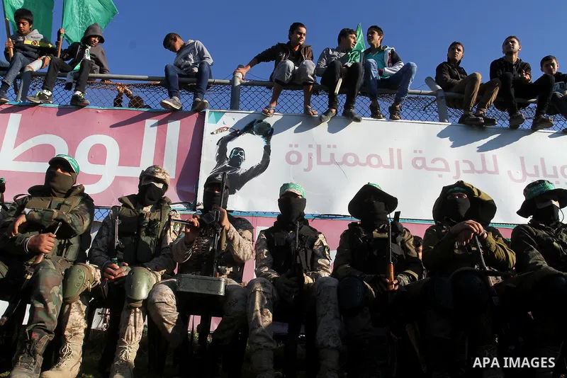 Members of the Ezzedine al-Qassam Brigades, the military wing of the Palestinian Islamist movement Hamas, take part in a rally marking the 29th anniversary of the founding of the Hamas movement, in Khan Younis in the sou...