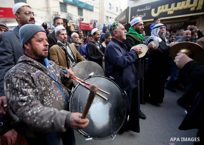 Palestinians Muslim Sufis play musical instruments as they parade through the streets during a ceremony commemorating the birth of Prophet Mohammed, known in Arabic as "Mawlid al-Nabawi", in the West Bank city of Nablus...