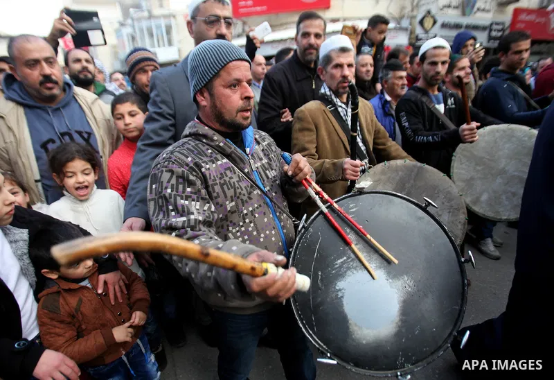 Palestinians Muslim Sufis play musical instruments as they parade through the streets during a ceremony commemorating the birth of Prophet Mohammed, known in Arabic as "Mawlid al-Nabawi", in the West Bank city of Nablus...