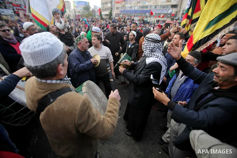 Palestinians Muslim Sufis play musical instruments as they parade through the streets during a ceremony commemorating the birth of Prophet Mohammed, known in Arabic as "Mawlid al-Nabawi", in the West Bank city of Nablus...
